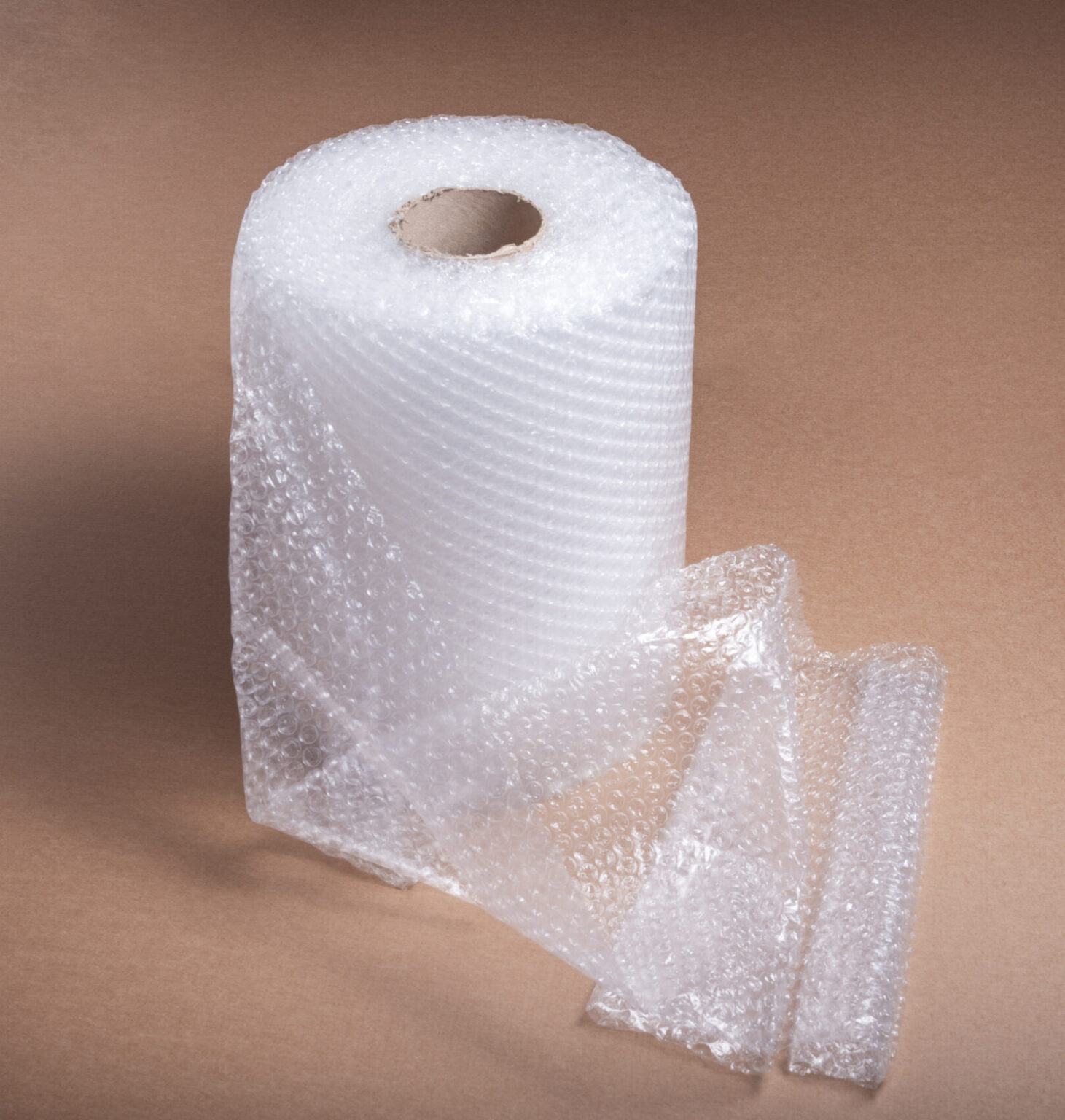 Roll of bubble film on brown cardboard background